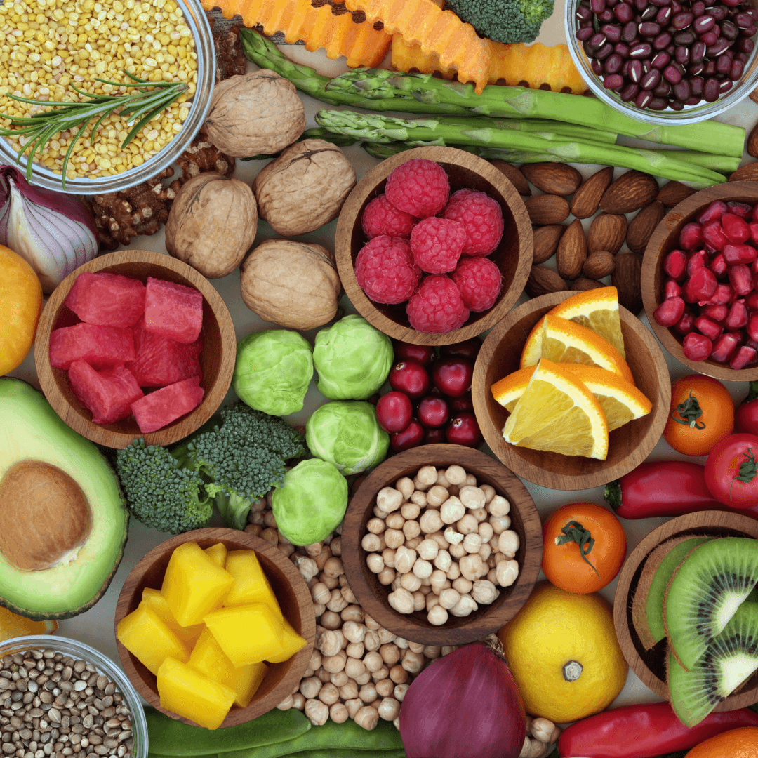 Fruit, vegetables, nuts and pulses in small wooden bowls