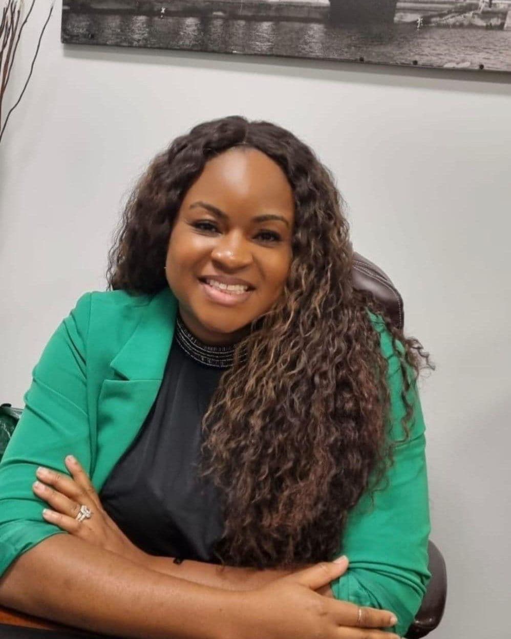 The founder of Lilyflow, smiling at her desk